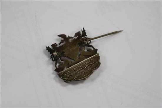 A Chinese white metal chop sticks stand and two ceremonial medallions.